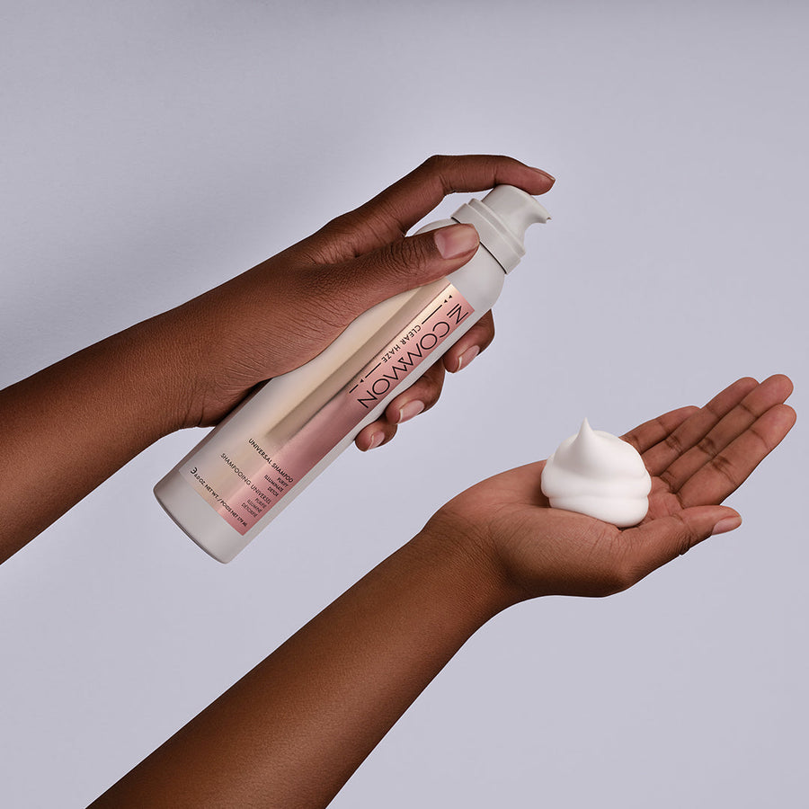 image shows arms focused on hands with shampoo bottle showing the foam shampoo in hand